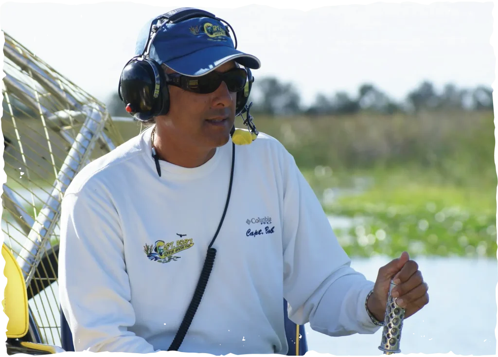 Captain Bob wearing a headset and sunglasses while piloting an airboat in Vero Beach.